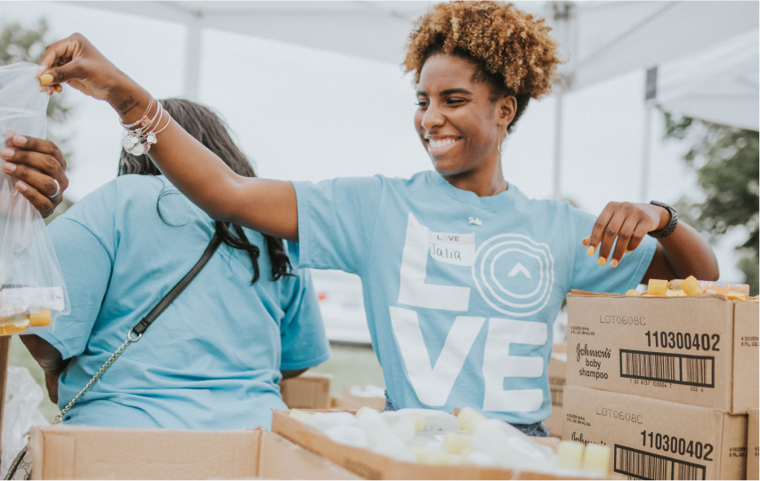 Volunteers packing food at Love Week event